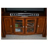 STORAGE BASE UNDER TV. ALSO SHOWING THE THEATER SOUND SYSTEM