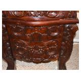 DRAWER PULLS ARE CARVED INTO THE FACE OF THE DRAWERS