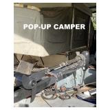 TROLLING MOTOR ON BOAT. POPUP CAMPER AT TOP OF PIC