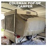 COLEMAN POPUP CAMPER. REAR VIEW. STORED UNDER COVER.