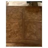 TABLE HAS BURLED WOOD DESIGN ON TIP