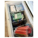 INSIDE VIEW OF FREEZER. HAS MULTIPLE BASKETS FOR IT