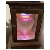 CRANBERRY VASE HIGHLY LIGHTED IN THE SMALLER SHOWCASE