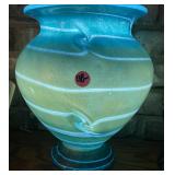 ARTGLASS VASE WITH LIGHT SHINING INSIDE IT
