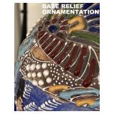 CLOSEUP OF BASE-RELIRF HAND APPLIED ORNAMENTATION