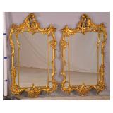 pair of ornate gold framed mirrors 