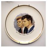 JFK Collectors Plate With Assortment Of Coffee Mugs, Trivets, Glassware And Wood Shelf