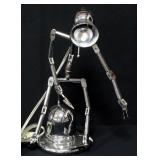 Metal Table Lamp Designed Like A Metal Person, Arms And Legs Articulate, The "Head" Is The Lamp, 15.
