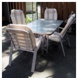 Metal Framed Patio Table With Tempered Glass Top And Matching Metal Chairs With Seat Cushions, Qty 4