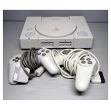 Play Station Model SCPH-5501 With 2 Controllers, 6 Games, And TV Connections