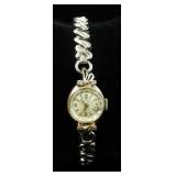 DeVille Ladies Wristwatch With 14K White Gold Backing And Clear Stones, Possibly Diamond, And 1/20 1