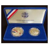 1986 Liberty Coins, Includes 1986 Liberty Silver Dollar, .900 Fine Silver, And 1986 Liberty Half Dol