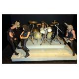 Pair of Stage Sets with Full Drum Sets and 4 Band Members Each  