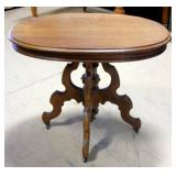Elaborately Carved Oval Pedestal Table on Wheels 35.5"W x 29"H