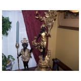 One of a pair of bronze nubian torchbearer and lamp