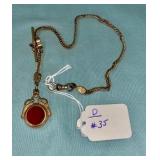 GOLD PLATED WATCH CHAIN W/ RED STONE