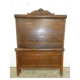OAK HIGHBACK BED W/ ROLL/CARVINGS