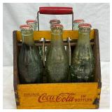 Wooden Coca-Cola Bottle Carrier with Six Glass Bottles, Metal Handle, and Red Caps