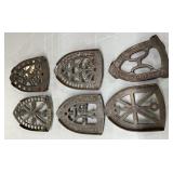 Six Cast Metal Iron Trivets with Various Patterns and Markings