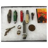 Pocket Knives, Toy Revolver, Rings, Wristwatch, Coin, and Comic Book