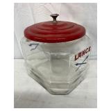 Lance Glass Jar with Red Metal Lid and Crossed Arrows Motif, 7×8 Inches