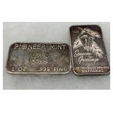 Two 1 oz .999 Fine Silver Bars: ‘Pioneer Mint’ and ‘1984 Seasons Greetings’