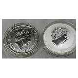 Four Silver Coins Featuring Queen Elizabeth II, Britannia, and James Bond Designs