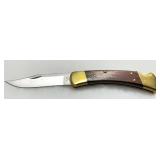 Buck Model 110 Folding Knife with Brass Bolsters and Wood Handle