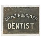 Early Dr. N.E. Ruediger Dentist Tin Sign, 22in x 17in