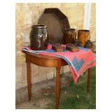 Demi-lune cherry table, primitive quilt, dovetailed wood bowl, various crocks and wood carved trim