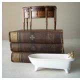 Louisa May Alcott books and dollhouse furniture.