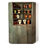 New England painted pine corner cupboard and a selection of American earthenware, many examples...