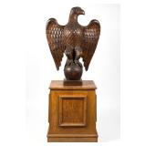 American carved pine eagle of impressive size on a paint-decorated podium, both likely lodge...