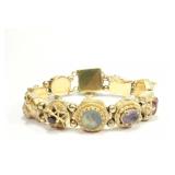 Lot 220: Yellow Gold Charm Bracelet 