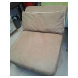 Armless lounging chair with pillow.