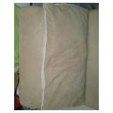 Armless lounging chair with pillow.