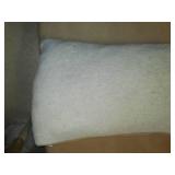 Armless lounging chair with pillow.