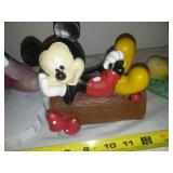 Three Mickey Mouse figurines.