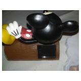 Three Mickey Mouse figurines.