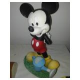 Three Mickey Mouse figurines.