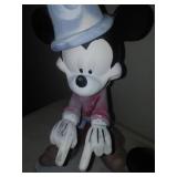 Three Mickey Mouse figurines.