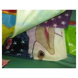 Tote and cover full of garden banners and flags.