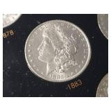 DATE SET OF 27 AU-BU MORGAN SILVER DOLLARS IN CAPITAL HOLDER