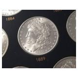 DATE SET OF 27 AU-BU MORGAN SILVER DOLLARS IN CAPITAL HOLDER