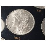 DATE SET OF 27 AU-BU MORGAN SILVER DOLLARS IN CAPITAL HOLDER