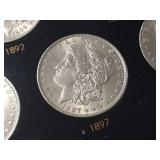 DATE SET OF 27 AU-BU MORGAN SILVER DOLLARS IN CAPITAL HOLDER