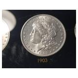 DATE SET OF 27 AU-BU MORGAN SILVER DOLLARS IN CAPITAL HOLDER