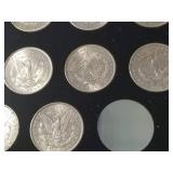 DATE SET OF 27 AU-BU MORGAN SILVER DOLLARS IN CAPITAL HOLDER