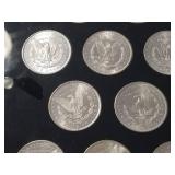 DATE SET OF 27 AU-BU MORGAN SILVER DOLLARS IN CAPITAL HOLDER