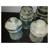 12 green glass insulators